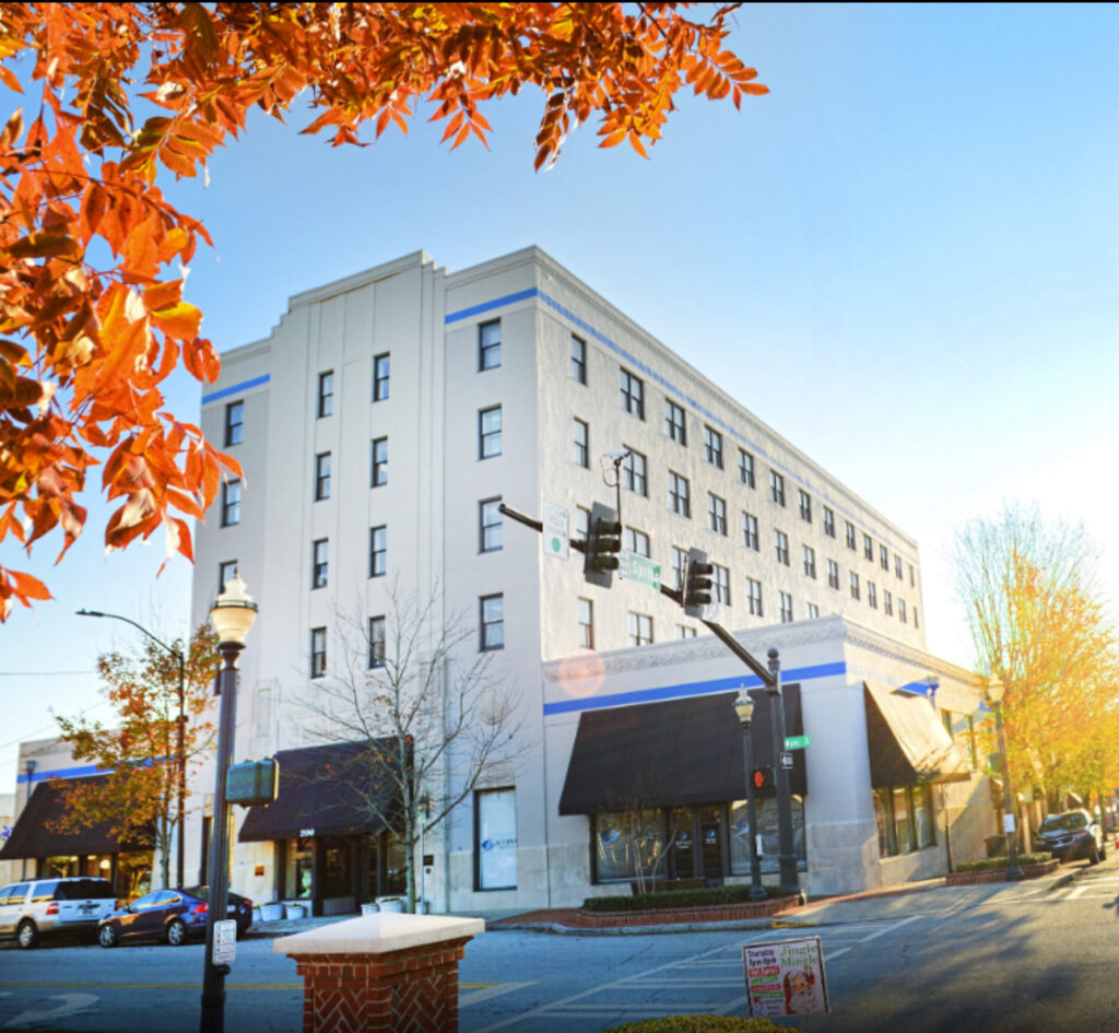 About Us 19 Well-lit interior of a professional office space with large windows, clean lines, and a welcoming layout.