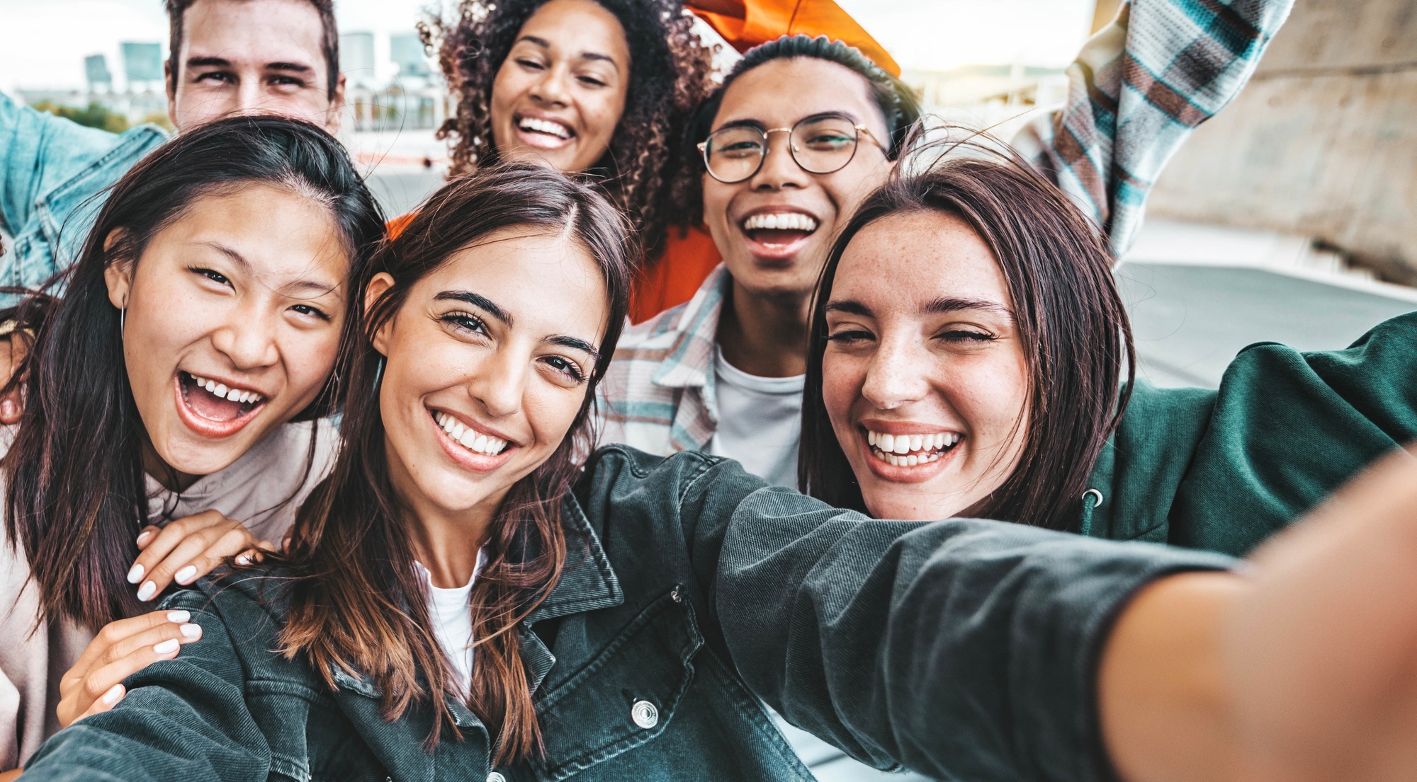 Happy best friends taking selfie portrait outdoors