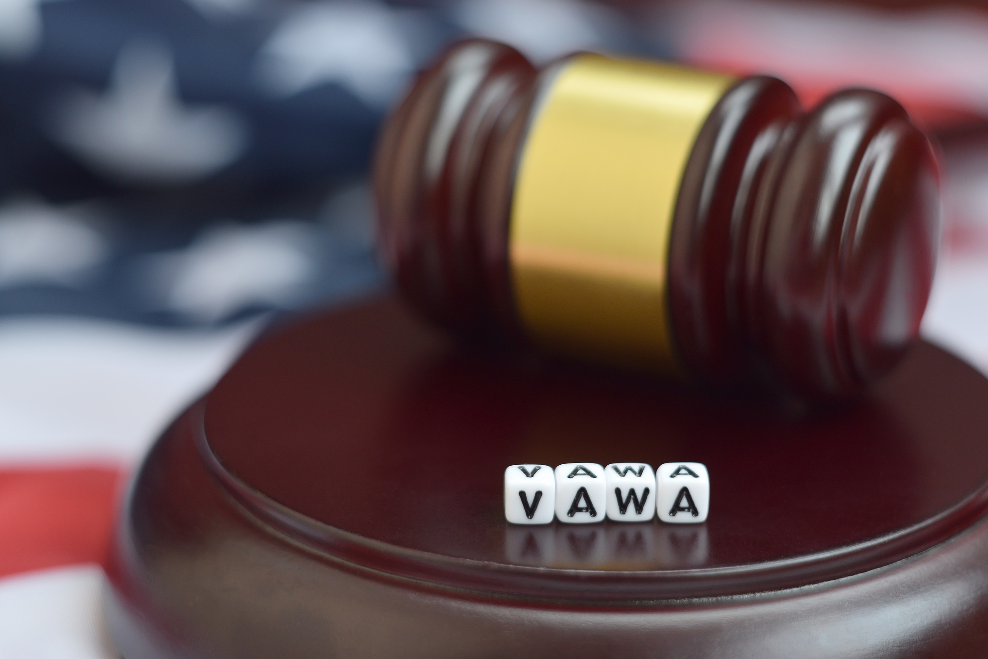 Justice mallet and VAWA acronym close up. Violence against women act